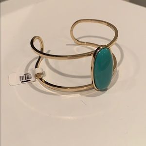 Gold bangle, turquoise colored stone
